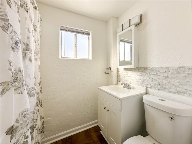 bathroom with vanity, curtained shower, wood-type flooring, and toilet