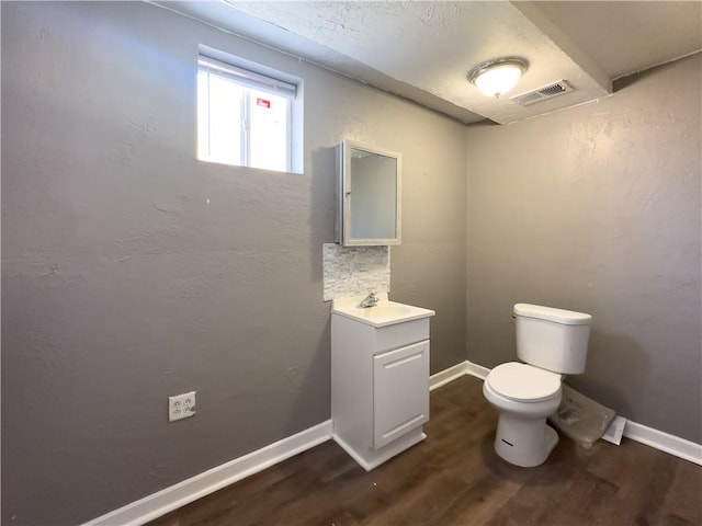 bathroom with vanity, backsplash, hardwood / wood-style floors, and toilet