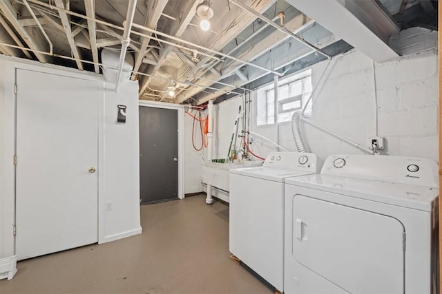 washroom with washer and clothes dryer and sink