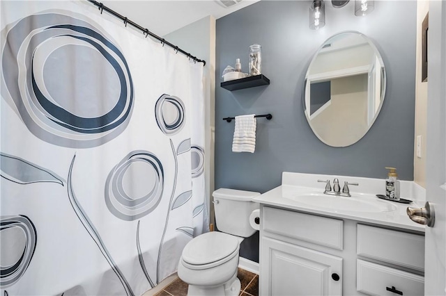 full bathroom with tile patterned flooring, shower / bath combination with curtain, vanity, and toilet