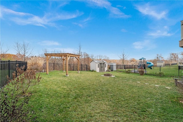 view of yard featuring a pergola, a playground, and a storage unit