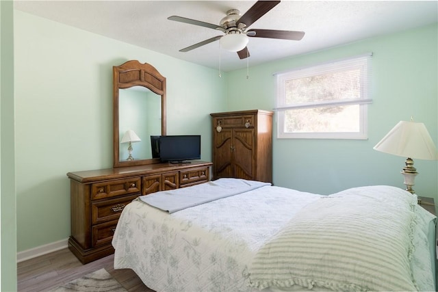 bedroom featuring ceiling fan and light hardwood / wood-style flooring