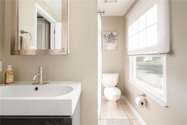 bathroom with tile patterned flooring, vanity, and toilet