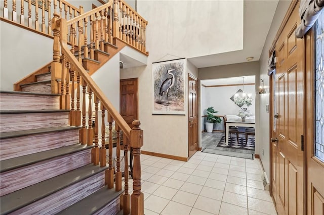 foyer with light tile patterned floors and a notable chandelier