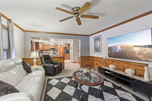 carpeted living room featuring ceiling fan and crown molding