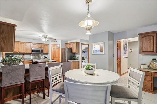 dining area with ceiling fan and light tile patterned flooring