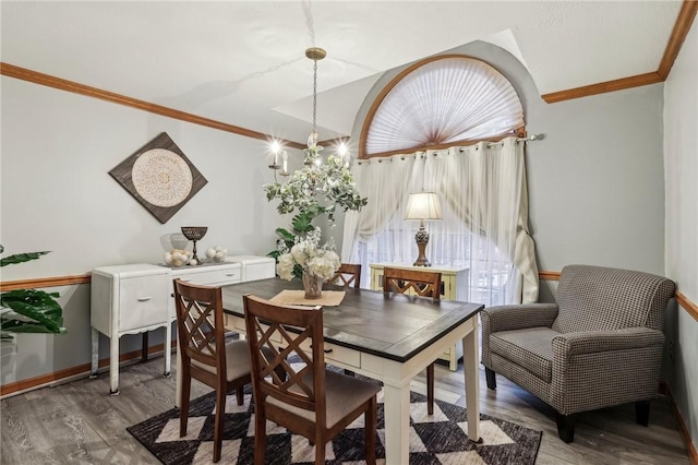 dining space featuring hardwood / wood-style floors and ornamental molding