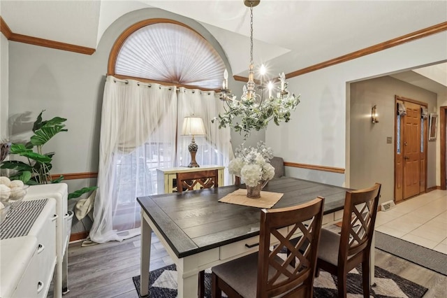 dining room with hardwood / wood-style floors, plenty of natural light, and ornamental molding