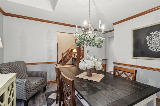 dining space with hardwood / wood-style floors, ornamental molding, and a notable chandelier