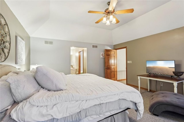 carpeted bedroom featuring ceiling fan, ensuite bath, and vaulted ceiling