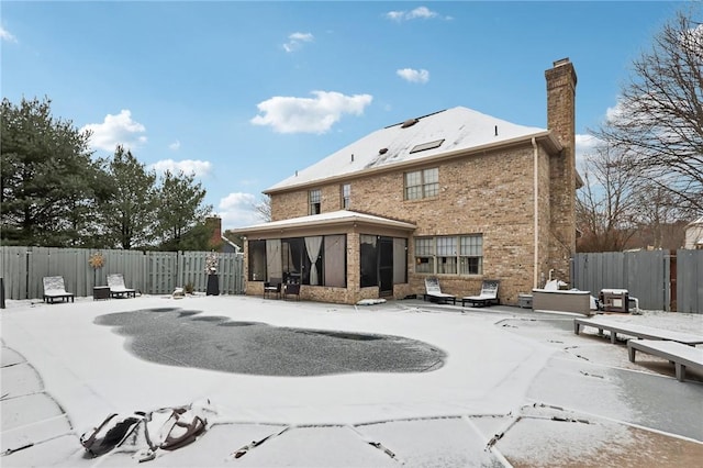 rear view of property featuring a sunroom