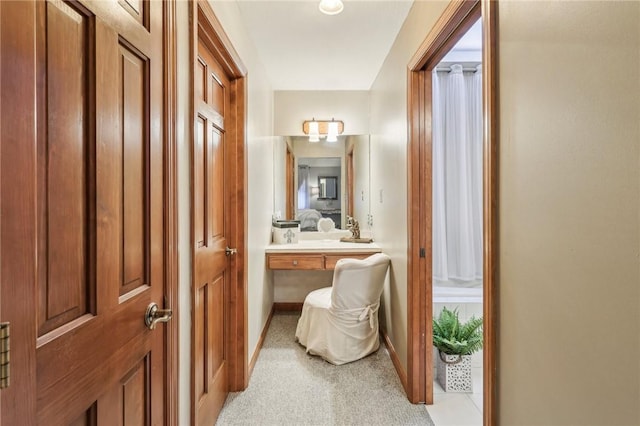 hallway with light colored carpet