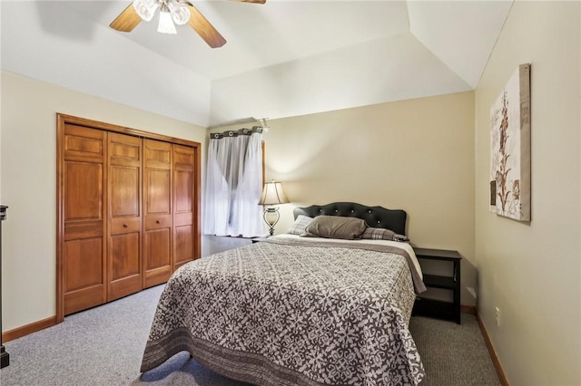 bedroom featuring a tray ceiling, ceiling fan, a closet, and carpet flooring