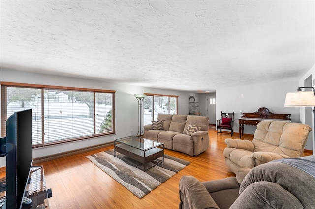 living room featuring a textured ceiling and light wood-type flooring