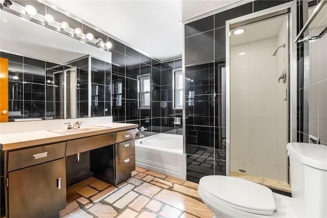 full bathroom featuring plus walk in shower, vanity, toilet, and tile walls