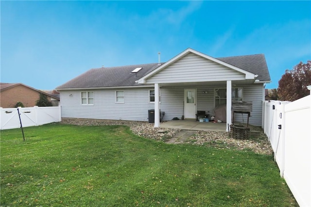 back of house with a lawn and a patio area