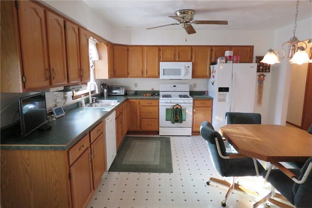 kitchen featuring ceiling fan with notable chandelier, white appliances, decorative light fixtures, and sink