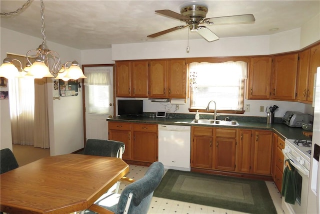 kitchen with ceiling fan with notable chandelier, white appliances, a healthy amount of sunlight, and sink