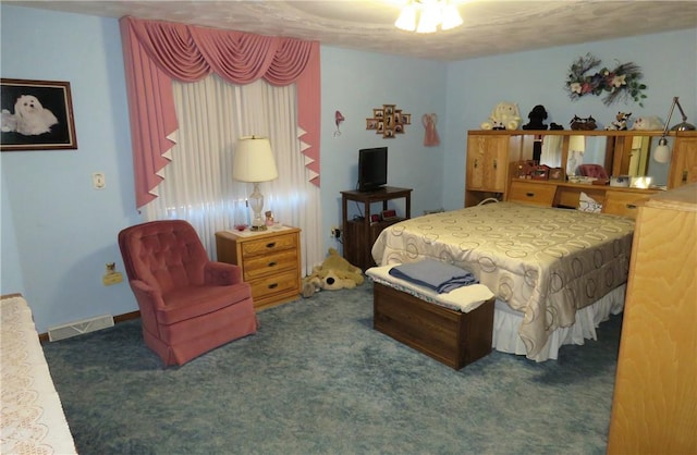 bedroom featuring dark carpet