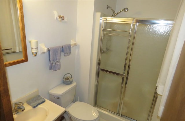 bathroom featuring toilet, sink, and walk in shower