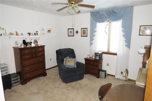 living area with light colored carpet, ceiling fan, and a healthy amount of sunlight