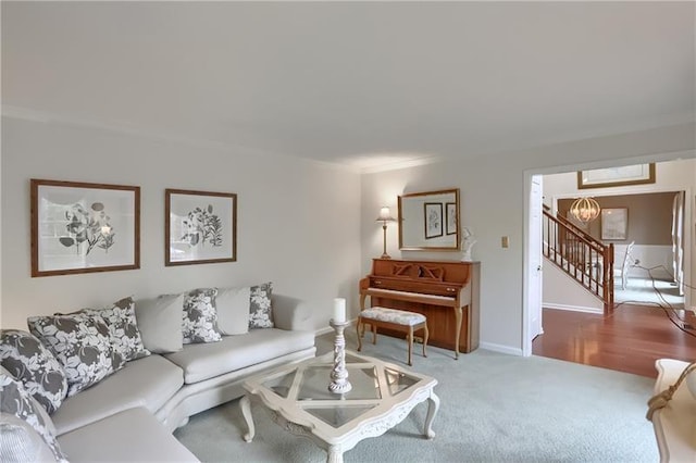 living room with carpet flooring and a notable chandelier