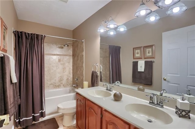 full bathroom with tile patterned flooring, shower / bath combo with shower curtain, vanity, and toilet