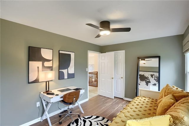 office area with ceiling fan and light hardwood / wood-style floors