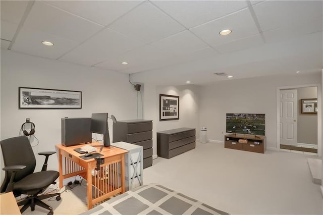 office area with a paneled ceiling and light carpet