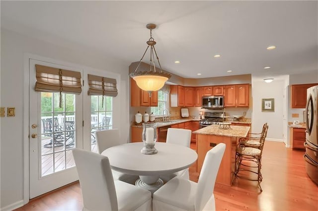 dining room featuring sink and light wood-type flooring