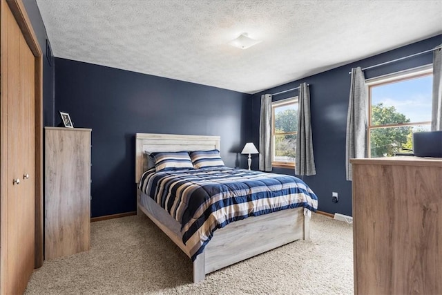 bedroom with carpet, a textured ceiling, and a closet