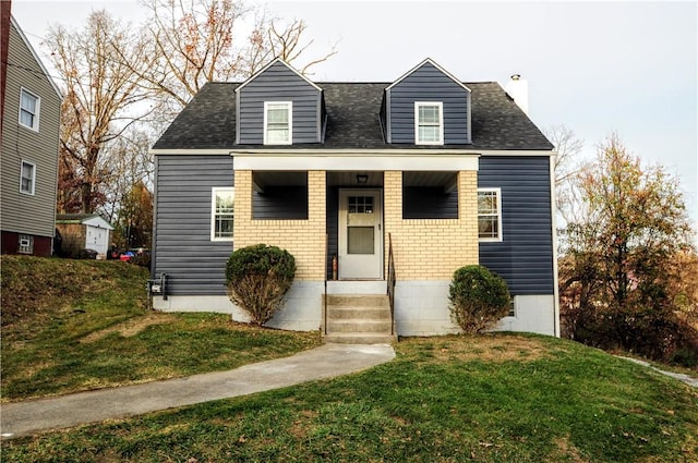 cape cod-style house with a front yard