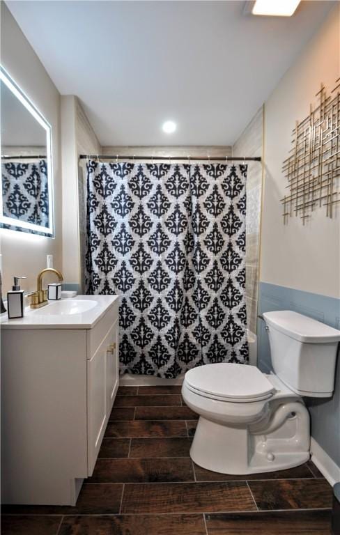 bathroom featuring vanity, a shower with shower curtain, and toilet