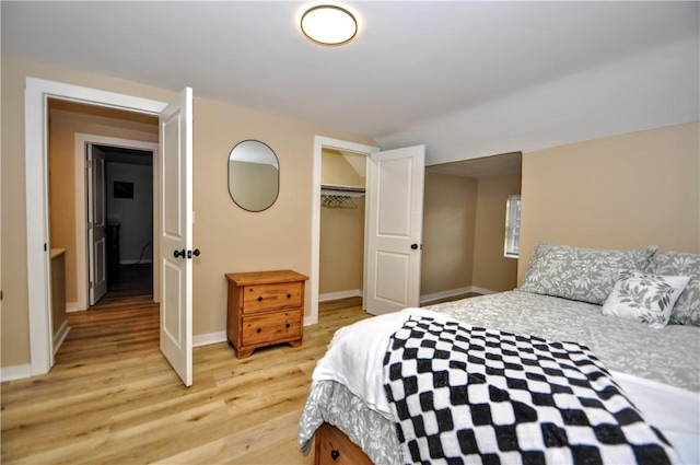 bedroom with light hardwood / wood-style flooring and a closet