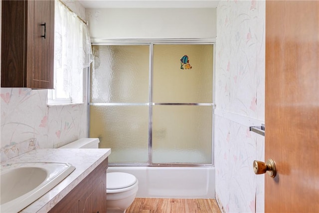 full bathroom with vanity, enclosed tub / shower combo, and toilet