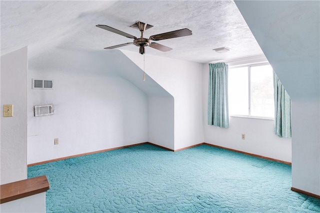 bonus room featuring a textured ceiling, carpet floors, vaulted ceiling, and ceiling fan