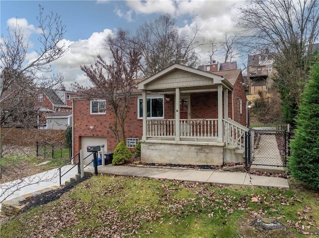 view of front of house featuring a porch and a garage