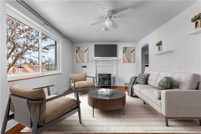 living room featuring ceiling fan and hardwood / wood-style floors