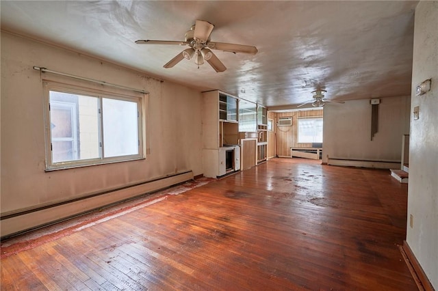 unfurnished living room with hardwood / wood-style flooring, ceiling fan, baseboard heating, and a wall unit AC