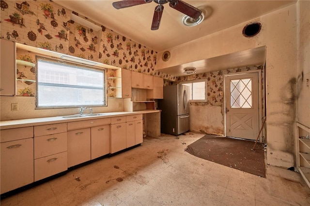 kitchen with stainless steel fridge, sink, and ceiling fan