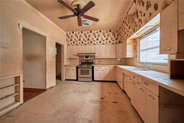 kitchen featuring ceiling fan, sink, and stainless steel range with gas stovetop