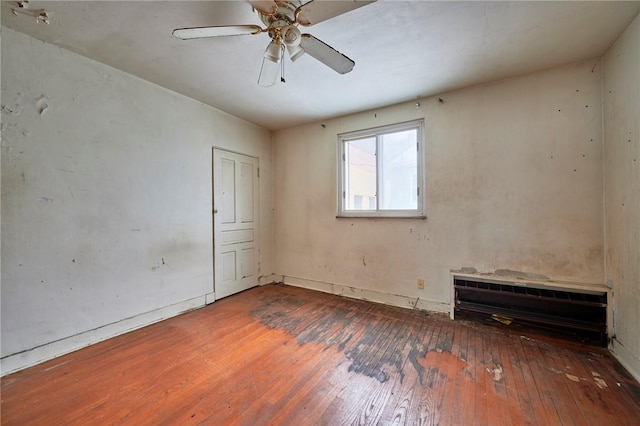 empty room with ceiling fan and wood-type flooring