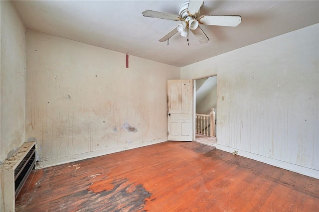 empty room featuring ceiling fan and hardwood / wood-style flooring