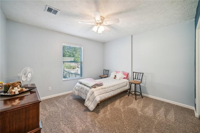 carpeted bedroom featuring a textured ceiling and ceiling fan