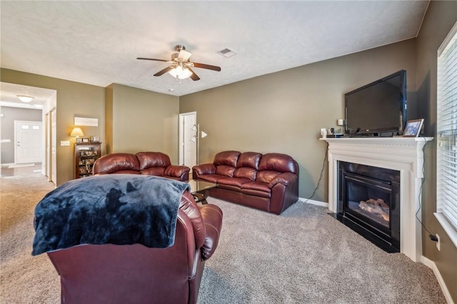 carpeted living room with ceiling fan