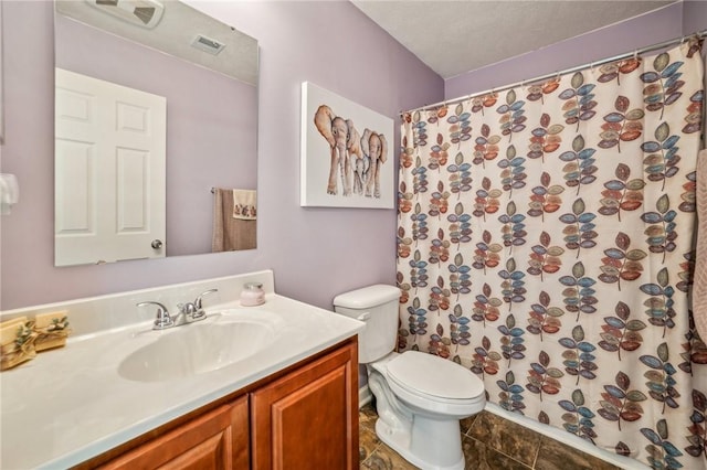 bathroom with a textured ceiling, vanity, toilet, and a shower with curtain