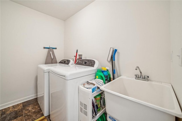 clothes washing area featuring washer and dryer and sink