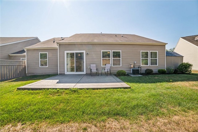 rear view of house featuring a lawn and a patio area