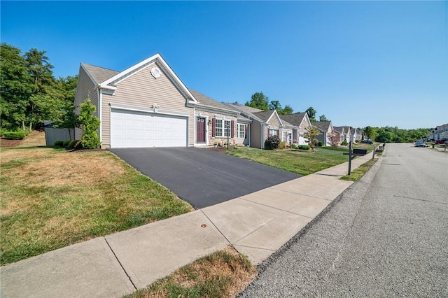 view of front of house with a garage and a front yard