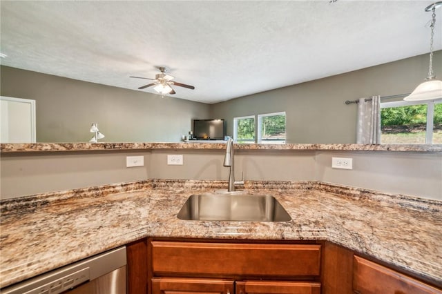 kitchen featuring a wealth of natural light, dishwasher, pendant lighting, and sink